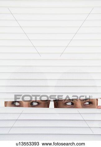 Two women look through blinds View Large Photo Image Stock Image - Two women look through blinds. Fotosearch