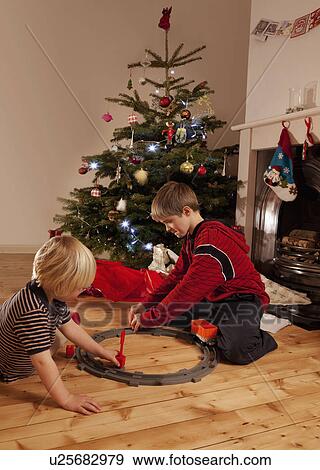Stock Photo - Two young boys playing with a train set. Fotosearch