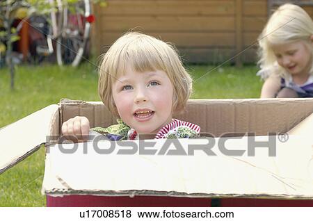 two young girls playing in cardboard box View Large Photo Image Stock Photo - two young girls playing in cardboard box. Fotosearch