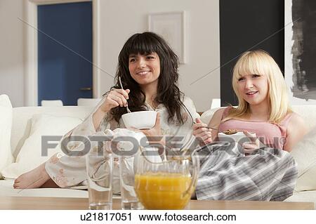 Two young women enjoying breakfast View Large Photo Image Stock Image - Two young women enjoying breakfast. Fotosearch