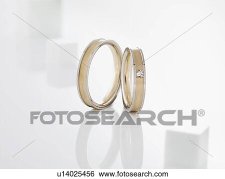 Wedding rings on reflective surface View Large Photo Image Stock Photograph - Wedding rings on reflective surface. Fotosearch