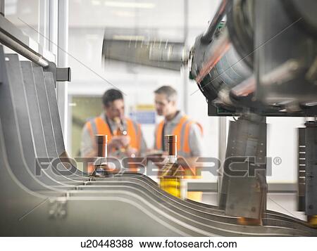 Stock Photo - Wine bottles in bottling machine. Fotosearch
