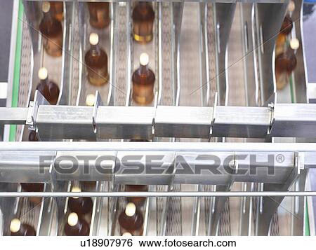 Wine bottles in bottling machine View Large Photo Image Stock Photograph - Wine bottles in bottling machine. Fotosearch
