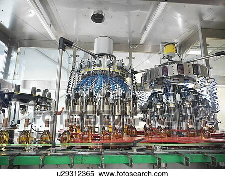 Stock Photography - Wine bottles in bottling machine. Fotosearch