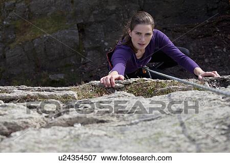 woman absailing with lake below View Large Photo Image Stock Photo - woman absailing with lake below. Fotosearch