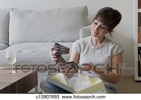 Stock Image - Woman admiring new shoe. Fotosearch