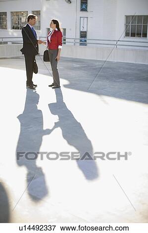 Woman and a man on a parking place View Large Photo Image Stock Photo - Woman and a man on a parking place. Fotosearch