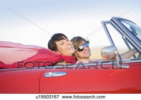 Woman and man in a convertible View Large Photo Image Stock Photo - Woman and man in a convertible. Fotosearch