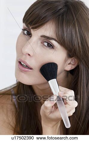 Stock Image - Woman applying foundation. Fotosearch