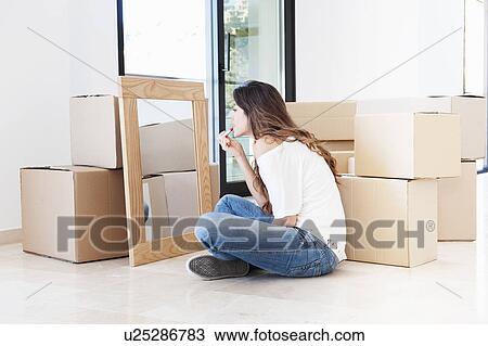 Woman applying lipstick in new home View Large Photo Image Stock Image - Woman applying lipstick in new home. Fotosearch
