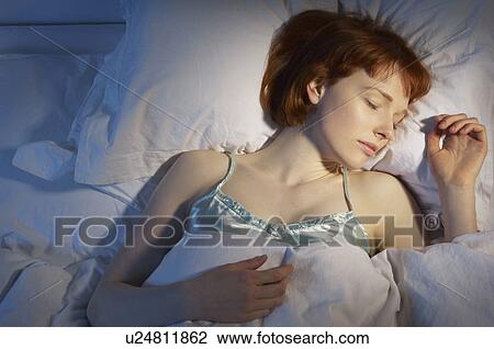 Stock Image - woman asleep in bed. Fotosearch