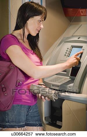 Woman at a cashpoint View Large Photo Image Stock Photo - Woman at a cashpoint. Fotosearch