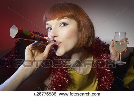 woman at party blowing party horn blower View Large Photo Image Stock Photograph - woman at party blowing party horn blower. Fotosearch