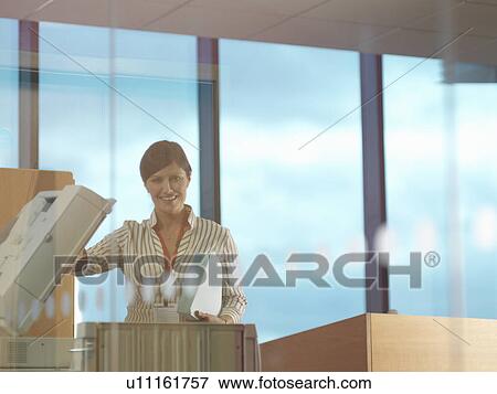 Stock Photo - Woman at photocopier. Fotosearch