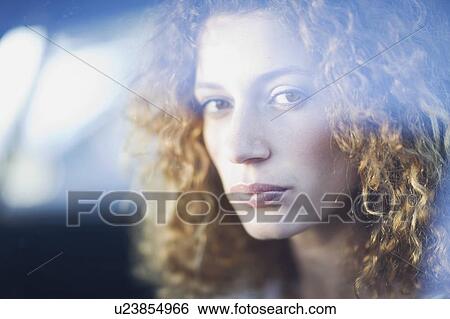 Stock Photograph - Woman behind a window. Fotosearch