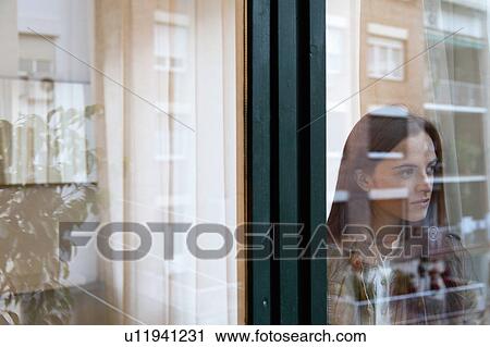 Woman by the window View Large Photo Image Stock Image - Woman by the window. Fotosearch