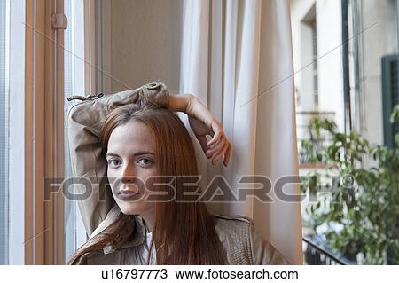 Stock Image - Woman by the window. Fotosearch