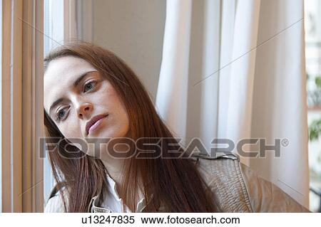 Woman by the window View Large Photo Image Stock Photography - Woman by the window. Fotosearch