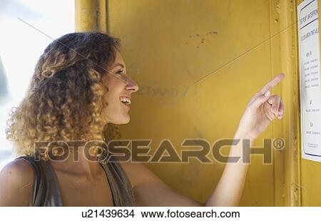 Woman checking a time table View Large Photo Image Picture - Woman checking a time table. Fotosearch