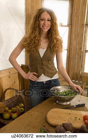 Woman chopping vegetables in kitchen View Large Photo Image Stock Image - Woman chopping vegetables in kitchen. Fotosearch
