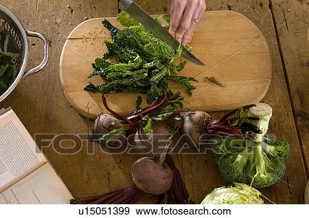 Woman chopping vegetables in kitchen View Large Photo Image Stock Photo - Woman chopping vegetables in kitchen. Fotosearch