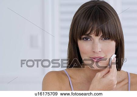 Woman cleaning her face View Large Photo Image Stock Photo - Woman cleaning her face. Fotosearch