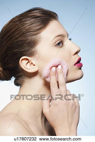 Stock Image - Woman cleansing her face. Fotosearch