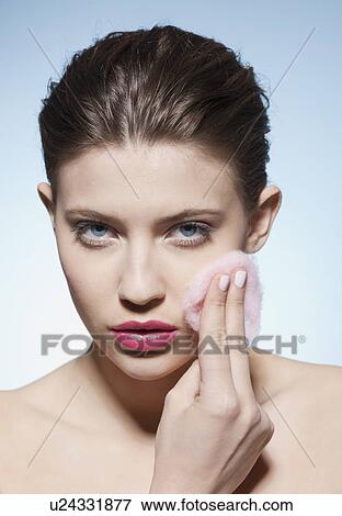Stock Photo - Woman cleansing her face. Fotosearch