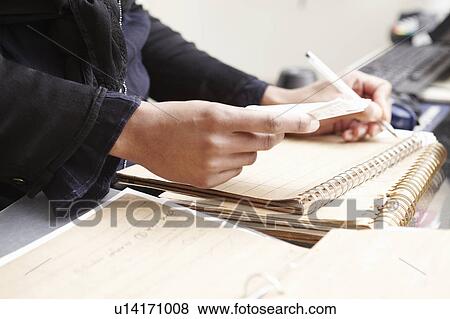 Stock Photo - Woman doing accounts. Fotosearch