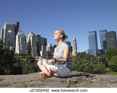 Woman doing yoga in central park View Large Photo Image Stock Image - Woman doing yoga in central park. Fotosearch