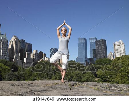 Woman doing yoga in central park View Large Photo Image Stock Photo - Woman doing yoga in central park. Fotosearch