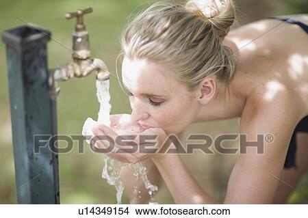 Picture - Woman drinkin fresh water. Fotosearch