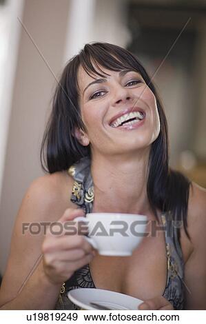 Woman drinking a cup of coffee View Large Photo Image Stock Photo - Woman drinking a cup of coffee. Fotosearch