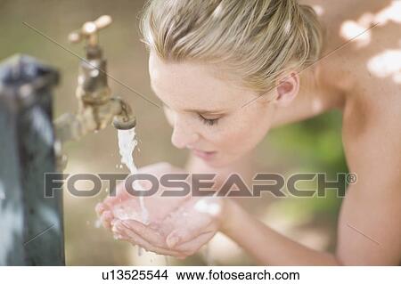 Woman drinking fresh water View Large Photo Image Picture - Woman drinking fresh water. Fotosearch