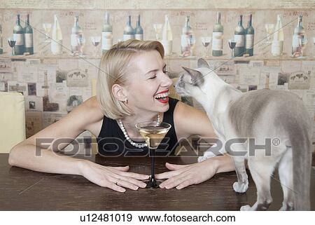 Woman drinking martini with cat View Large Photo Image Stock Photo - Woman drinking martini with cat. Fotosearch