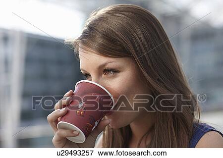 Stock Photo - Woman drinking out of coffecup. Fotosearch