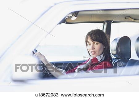Stock Image - Woman driving a car. Fotosearch
