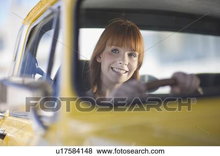 Woman driving a car View Large Photo Image Stock Photo - Woman driving a car. Fotosearch