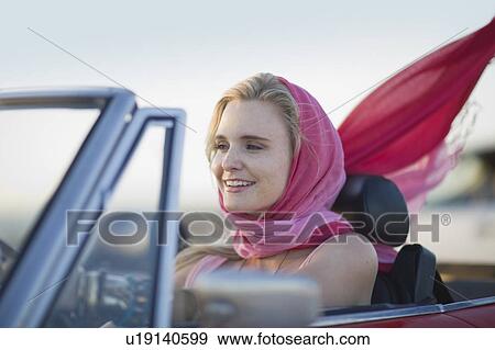 Woman driving a convertible car View Large Photo Image Stock Photo - Woman driving a convertible car. Fotosearch