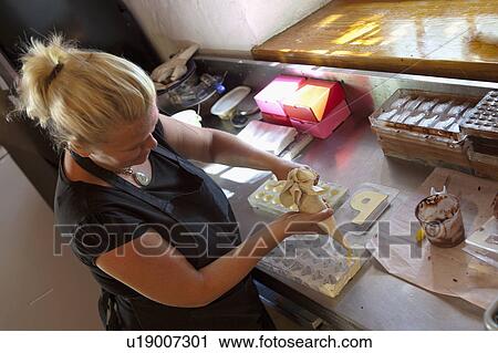 Woman extruding praline dought View Large Photo Image Stock Image - Woman extruding praline dought. Fotosearch