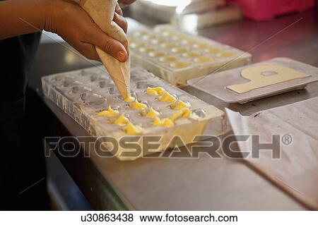 Woman extruding praline dought View Large Photo Image Stock Photo - Woman extruding praline dought. Fotosearch