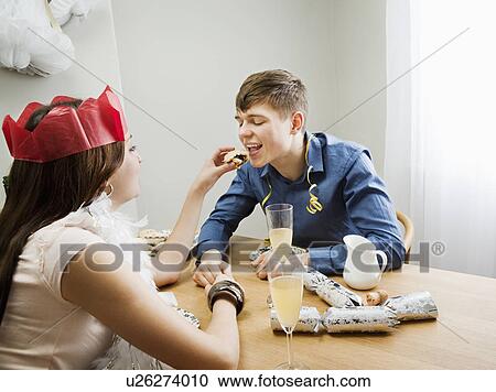 Woman feeding man mince pie View Large Photo Image Stock Image - Woman feeding man mince pie. Fotosearch