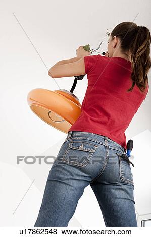 Woman fixing broken lamp View Large Photo Image Stock Photo - Woman fixing broken lamp. Fotosearch