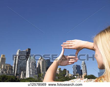 Woman framing the city with her hands View Large Photo Image Stock Photo - Woman framing the city with her hands. Fotosearch