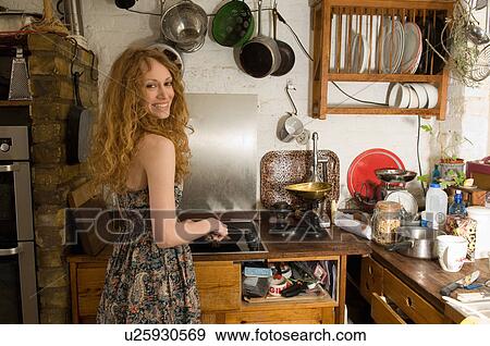 Woman frying vegetables in kitchen View Large Photo Image Stock Photo - Woman frying vegetables in kitchen. Fotosearch