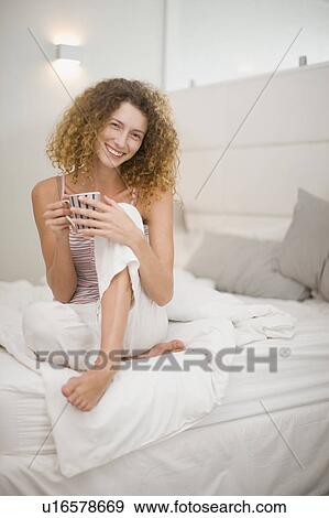 Woman having coffee in bed View Large Photo Image Stock Photo - Woman having coffee in bed. Fotosearch