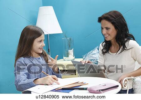 woman helping girl work View Large Photo Image Stock Photography - woman helping girl work. Fotosearch