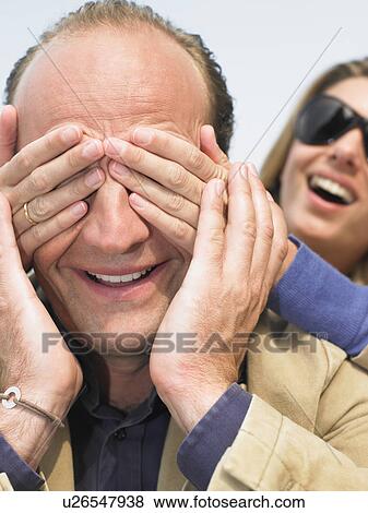 Woman hiding man's face with her hands View Large Photo Image Stock Photo - Woman hiding man's face with her hands. Fotosearch