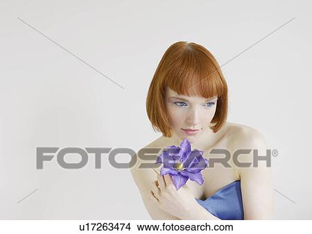 Picture - woman holding flower. Fotosearch