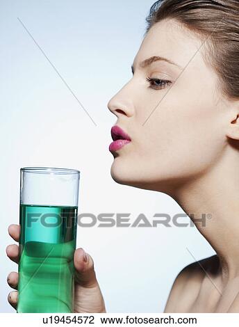 Woman holding glass of water View Large Photo Image Stock Image - Woman holding glass of water. Fotosearch